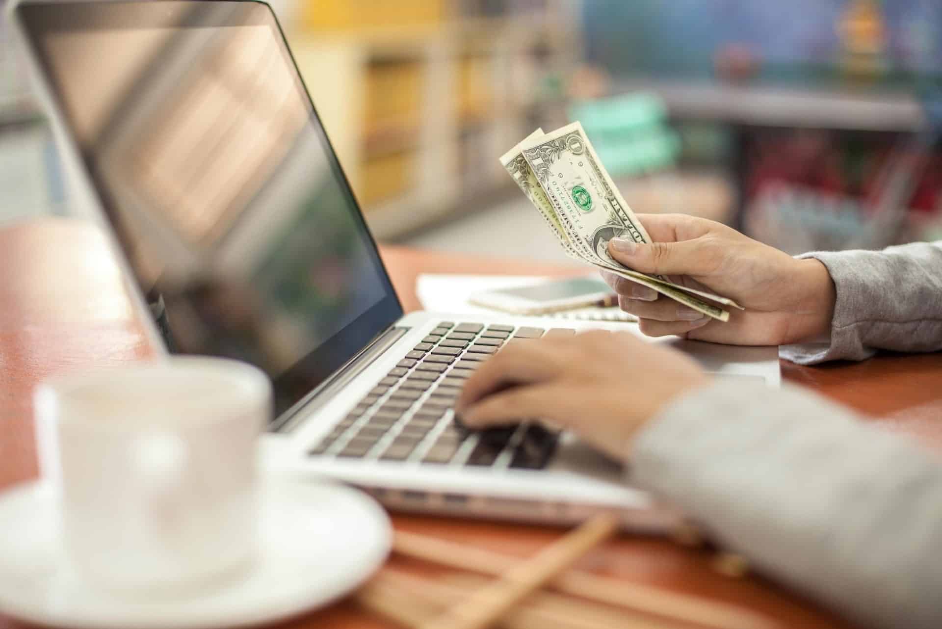 online-finances-with-laptop-and-paper-currency-2026-03-25-05-11-46-utc